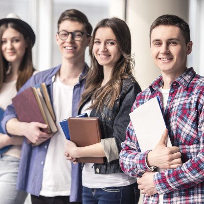 Group of happy young students in a university.