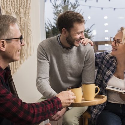 side-view-father-giving-mother-son-warm-cup_23-2148414872